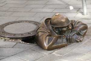 Statue of man in manhole