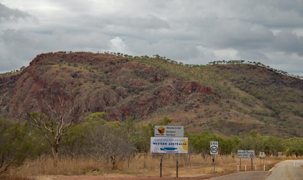 Over the border into the Northern Territory. Have a look at the speed signs - end of 80, then a notice that says max speed in NT is 110 unless signed. And up on the bend - it's 130. (130 is generally the max in NT. There's a LOT of empty space and not much traffic)