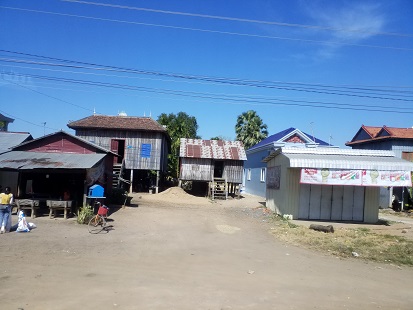 Shacks crowd the main road from Siem Reap