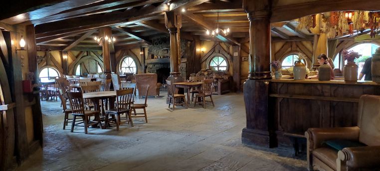Hobbiton Inside the Green Dragon with rustic exposed beams and a wooden floor. Cosy and rustic