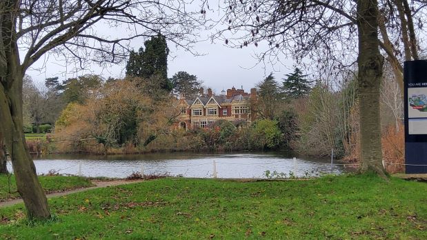 The imposing manor house above the lake at Bletchley Park