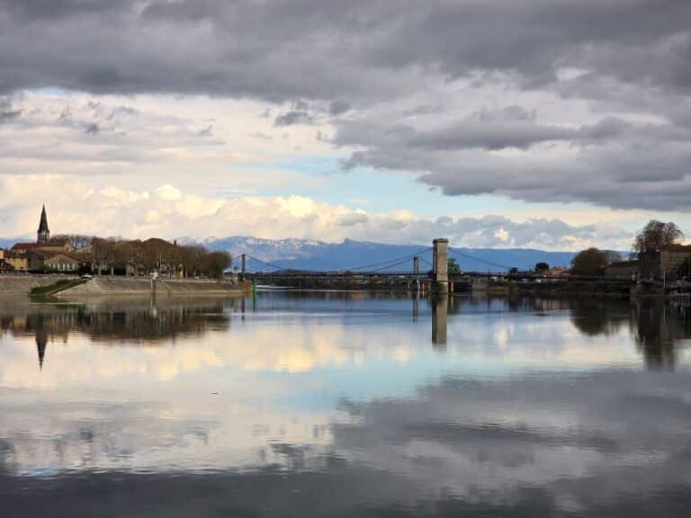 tournon showing the bridge between the two villages reflected in the Rhone river